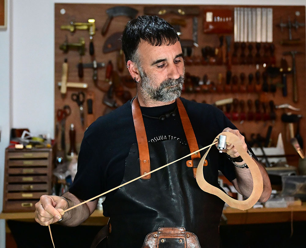 Isaac Romero leather craftsman in his workshop